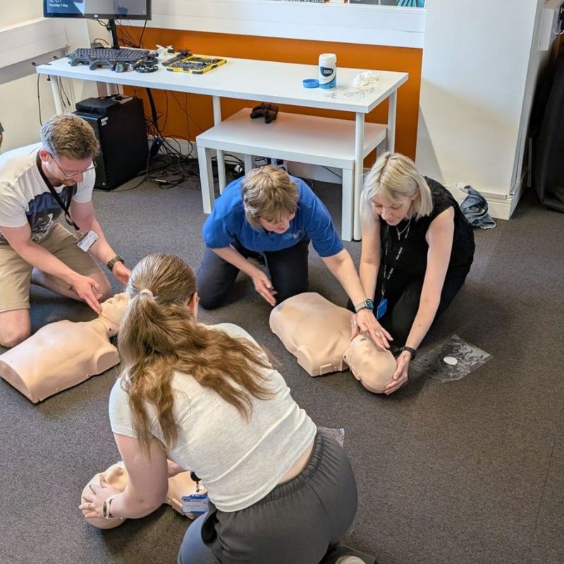 A workplace group photographed together after their on-site first aid course